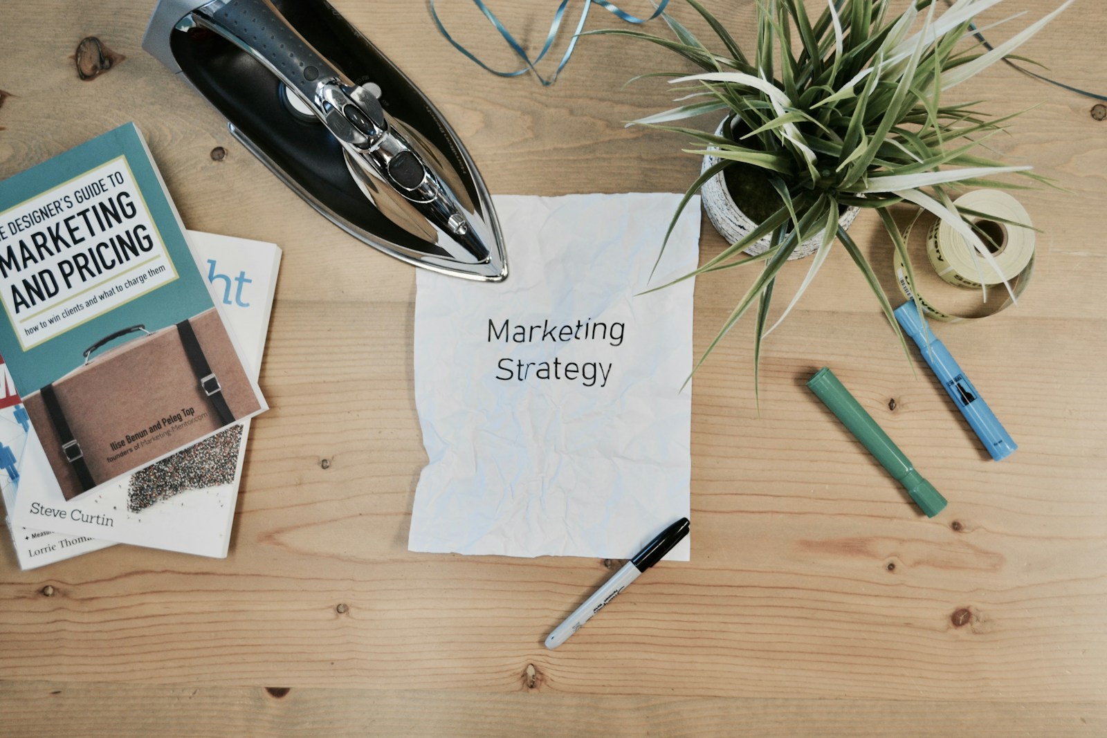 كيف تستخدم أتمتة التسويق (Marketing Automation) لزيادة كفاءة فريق مبيعات شركتك الصناعية؟ 24 white printing paper with Marketing Strategy text